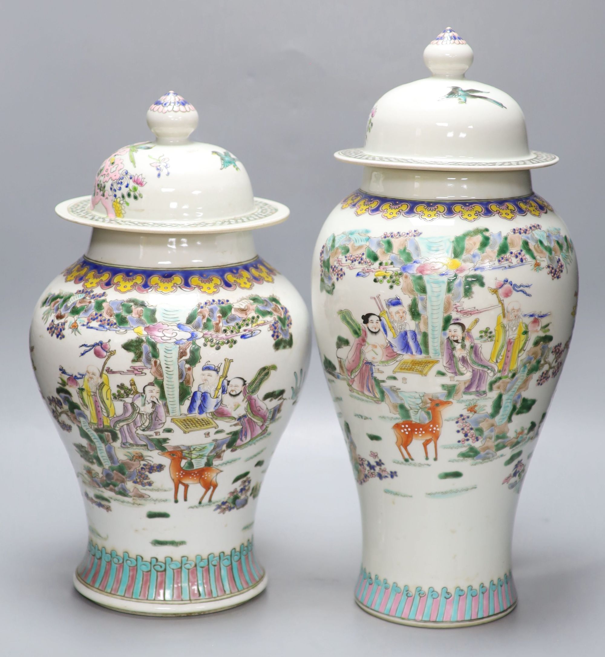 Two Chinese famille rose vases and covers, tallest 47cm